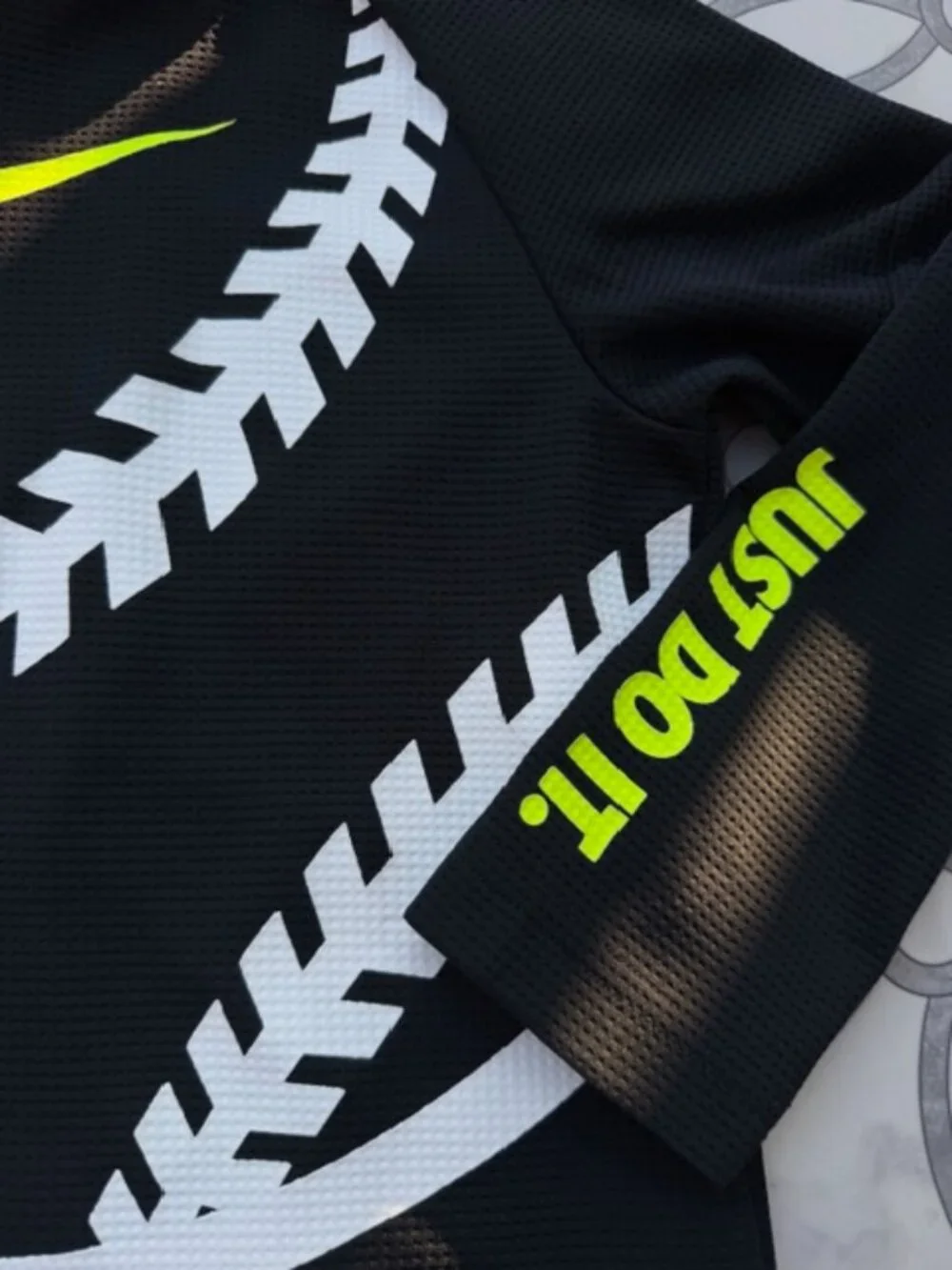 Nike Dri-FIT hoodie featuring a neon yellow swoosh logo and baseball stitching